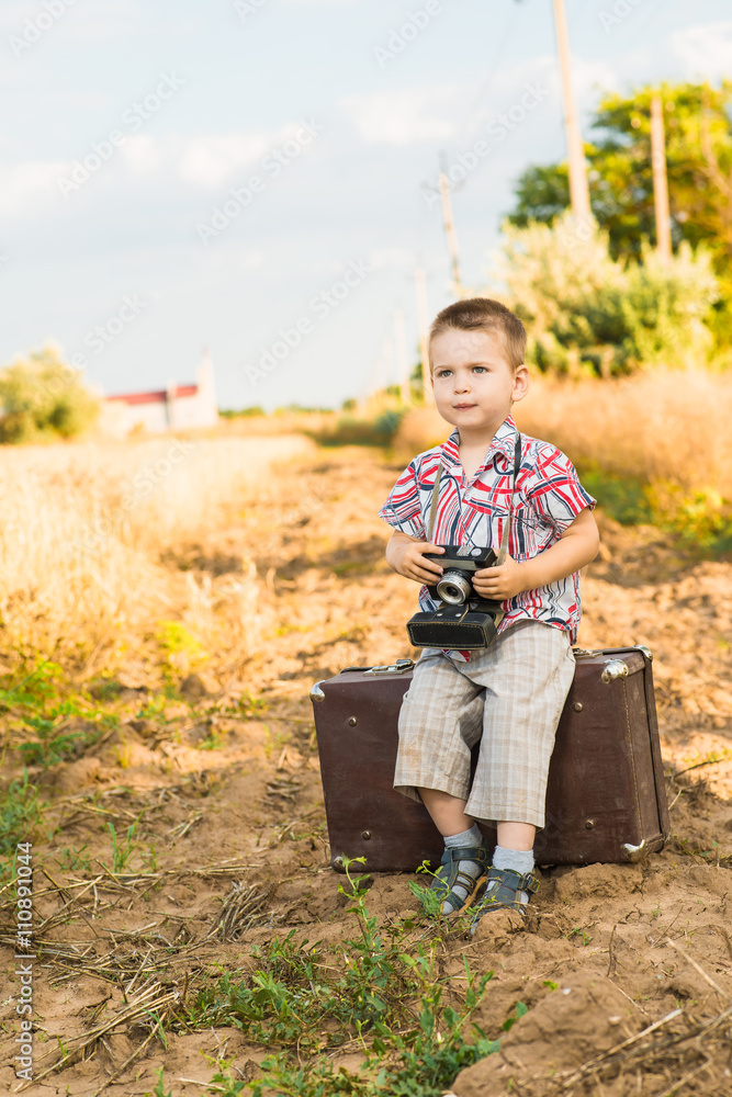 boy with a camera in nature