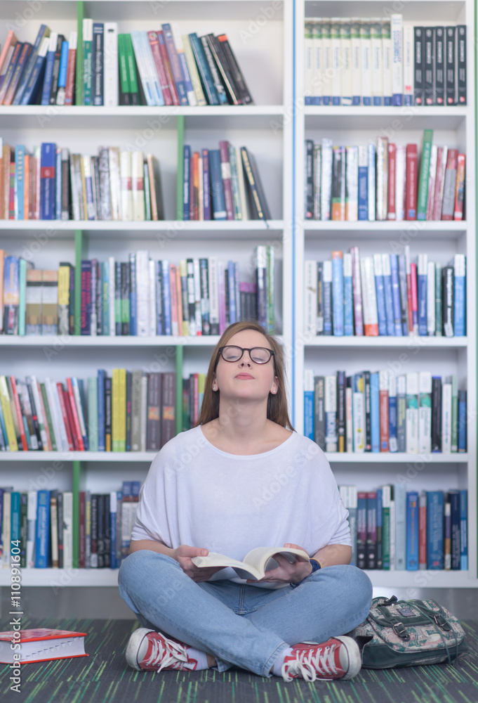 famale student reading book in library famale student reading book in library