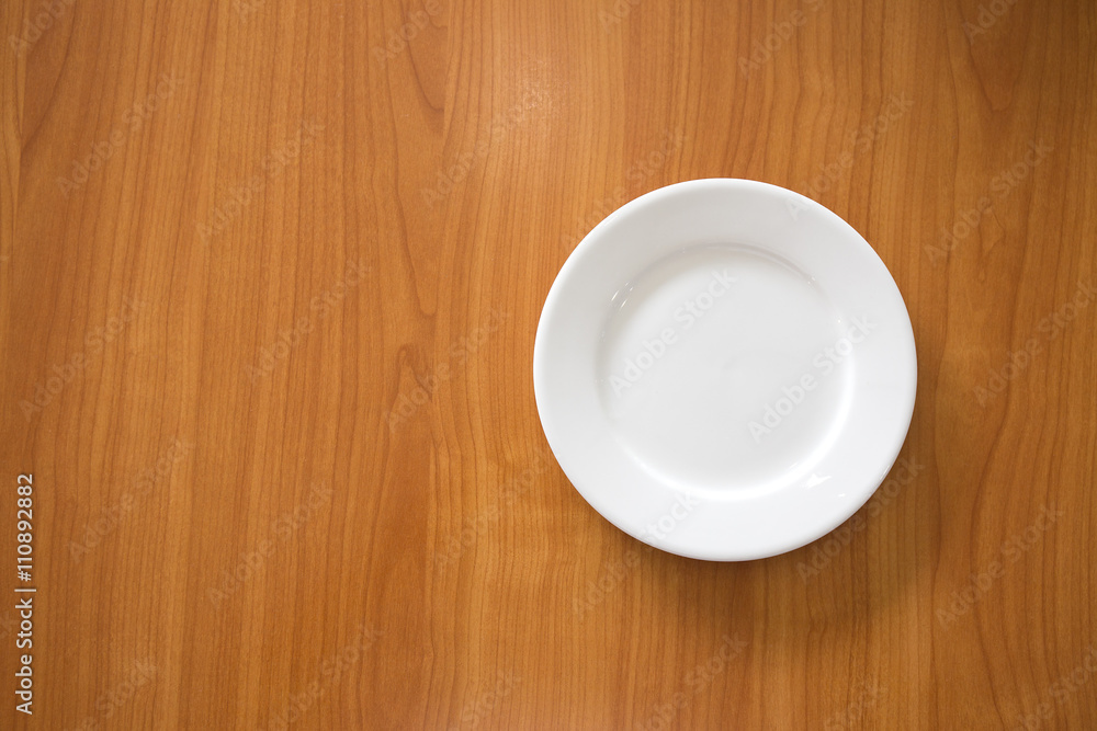 white circle ceramic dish on wood table with space white circle ceramic dish on wood table with space
