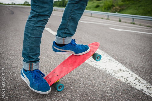 Stylish young guy on a red skateboard © dangutu
