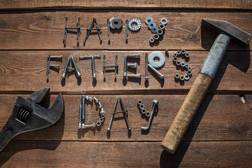 Happy Father's Day. Greeting card made of metallic bolts and iron nails