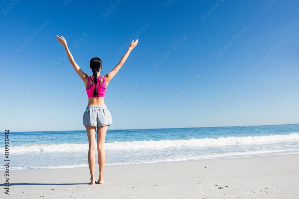 Woman with hands up on the beach Woman with hands up on the beach