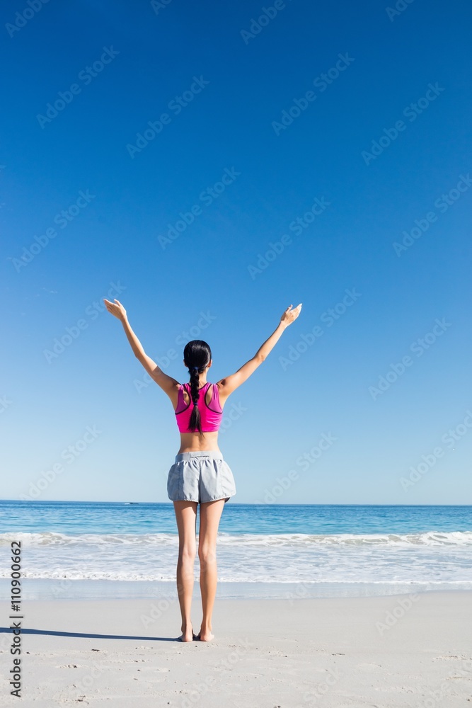 Woman with hands up on the beach Woman with hands up on the beach