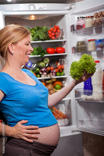 nutrition and diet during pregnancy. Pregnant woman standing nea