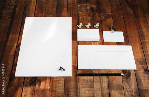 Photo of blank stationery set. Blank stationery template for branding identity for designers. Letterhead, business cards, badge, envelope and pencil.