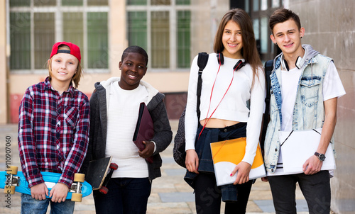Group of teens posing outside school