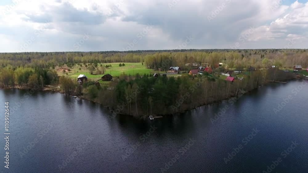 Flight to the lake shore village, aerial view. Small Russian village in woods. Russia
Flight to the lake shore village, aerial view. Small Russian village in woods. Russia