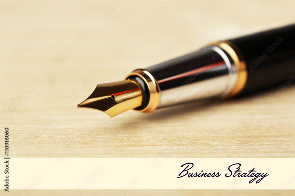 Fototapeta premium Fountain pen on wooden table background