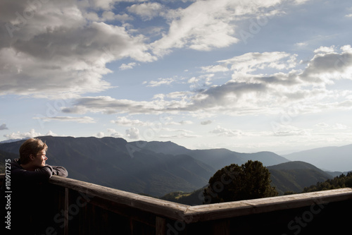 Male hiker gazing at view from balcony, Plose, South Tyrol, Italy photo