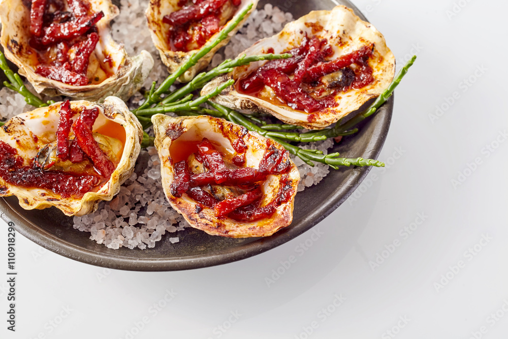 Plate of Oysters Kilpatrick on White Background Plate of Oysters Kilpatrick on White Background