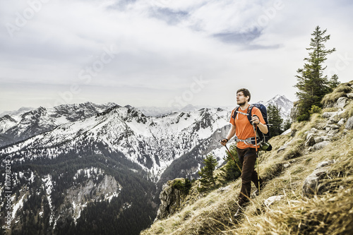 Young male hiker on peak of Klammspitze mountain, Oberammergau, Bavaria, Germany photo