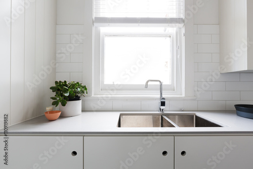 Close up details of contemporary white kitchen with subway tiles photo
