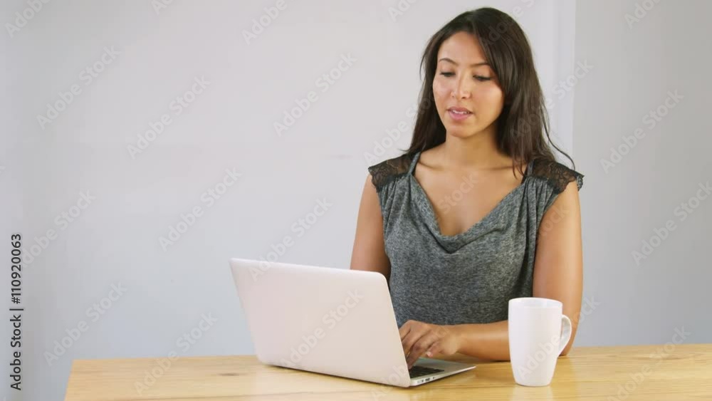 arabic woman using laptop computer in living room arabic woman using laptop computer in living room