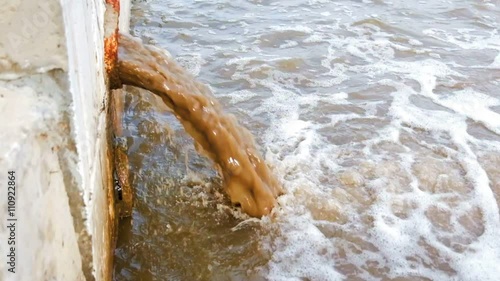 Waste pipe or drainage polluting environment. The drain carries sewage. Dirty water discharging directly in river