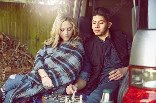 Young couple playing chess photo