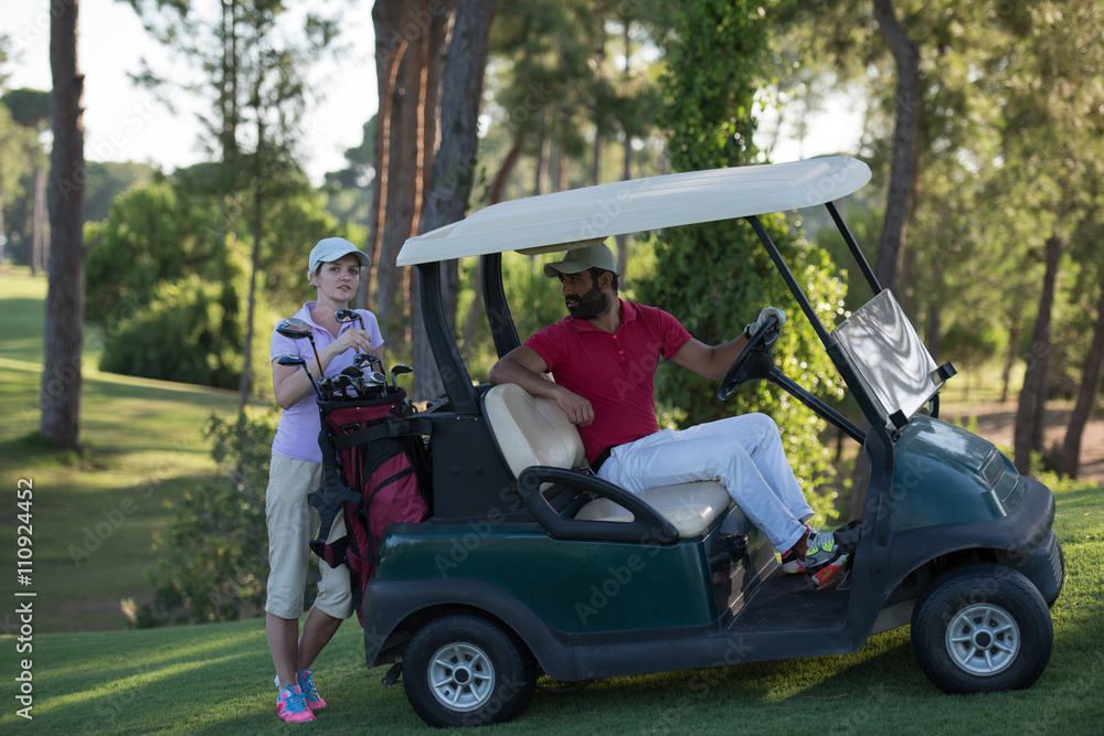 couple in buggy on golf course couple in buggy on golf course