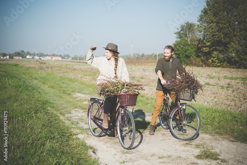 Young couple cycling in countryside, Dolo, Venice, Italy photo