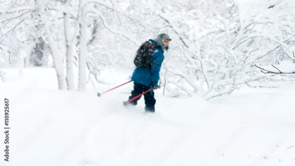 Skiing with Ski Poles Down the Powder Snow at the Mountain. Skiing with Ski Poles Down the Powder Snow at the Mountain.