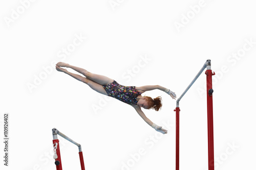 Young gymnast performing on uneven bars