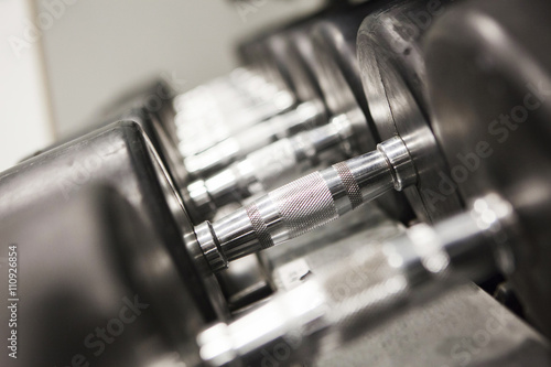 Dumbbells in a row, close-up photo