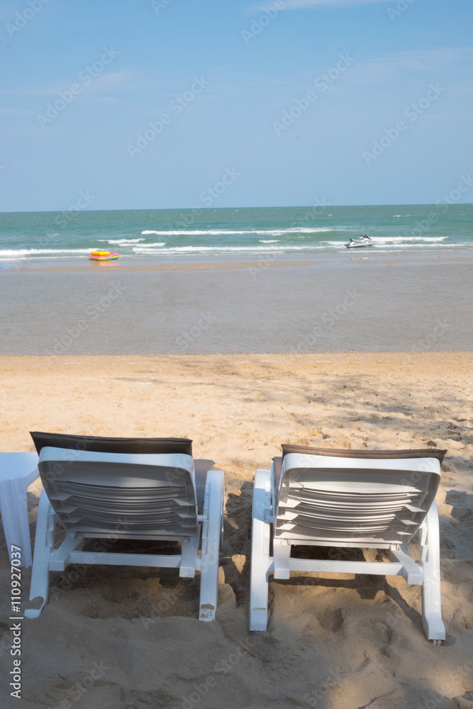 Beach bed, prepared for guests on sea beach background