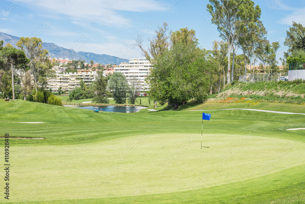 Fototapeta premium Golf course landscape with flag.