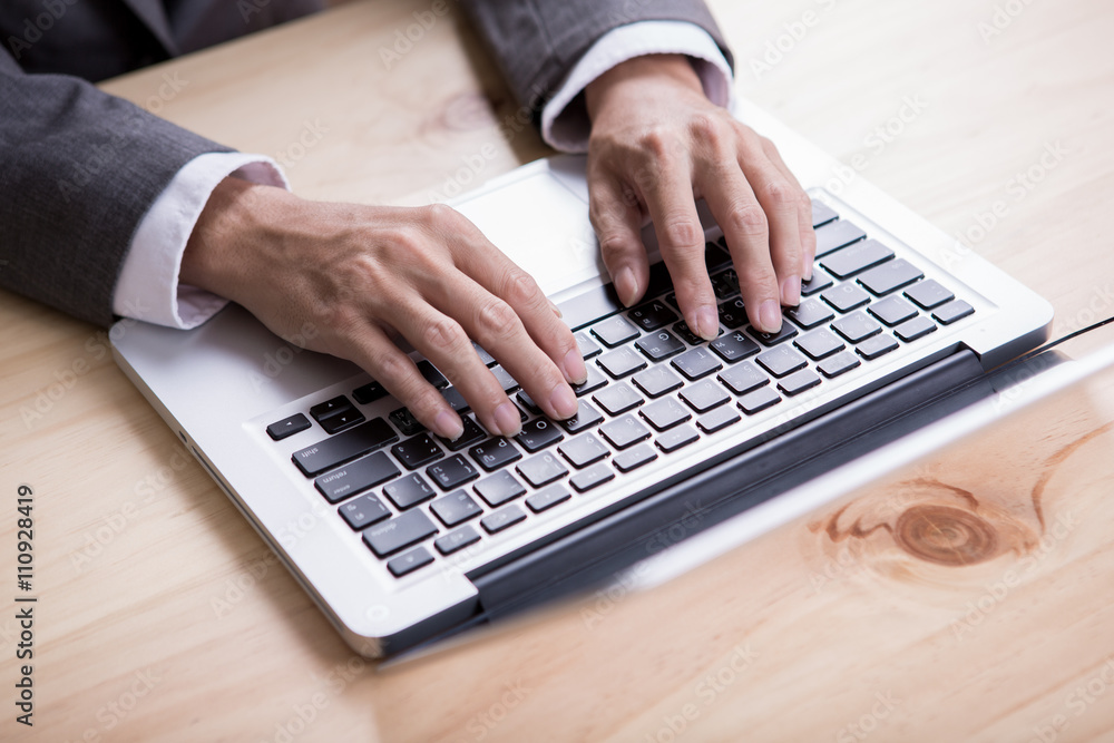 Closeup of businessman hands typing on laptop computer Closeup of businessman hands typing on laptop computer