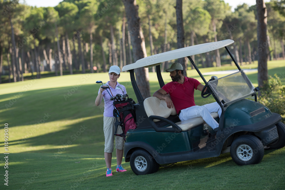 couple in buggy on golf course