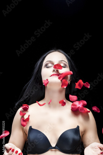Portrait of Caucasian Brunette Woman With Flying Rose Petals