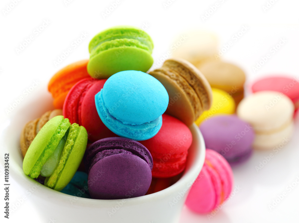Close up of colorful macarons in a white cup Close up of colorful macarons in a white cup