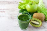 Blended green smoothie with ingredients selective focus 