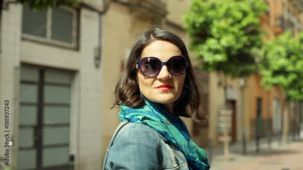 Woman walking in the city and looking to the camera, steadycam shot
Woman walking in the city and looking to the camera, steadycam shot