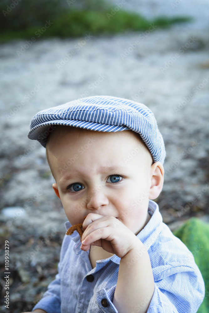 Portrait of baby boy wearing flat cap Stock Photo | Adobe Stock