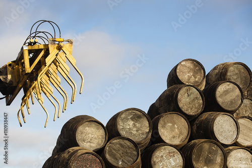Wooden whisky casks and grapple loader