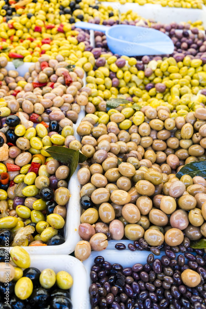 Olives, chilies, preserves in a French market in Paris, France Olives, chilies, preserves in a French market in Paris, France