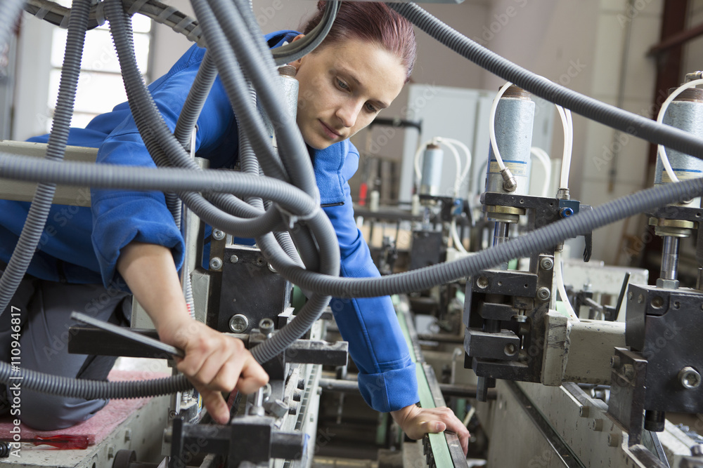 Factory worker working machinery Factory worker working machinery