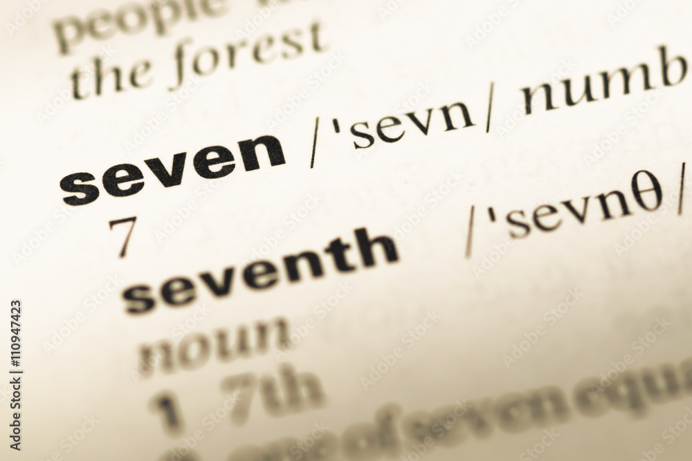 Close up of old English dictionary page with word seven Close up of old English dictionary page with word seven