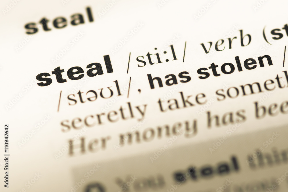 Close up of old English dictionary page with word steal Close up of old English dictionary page with word steal