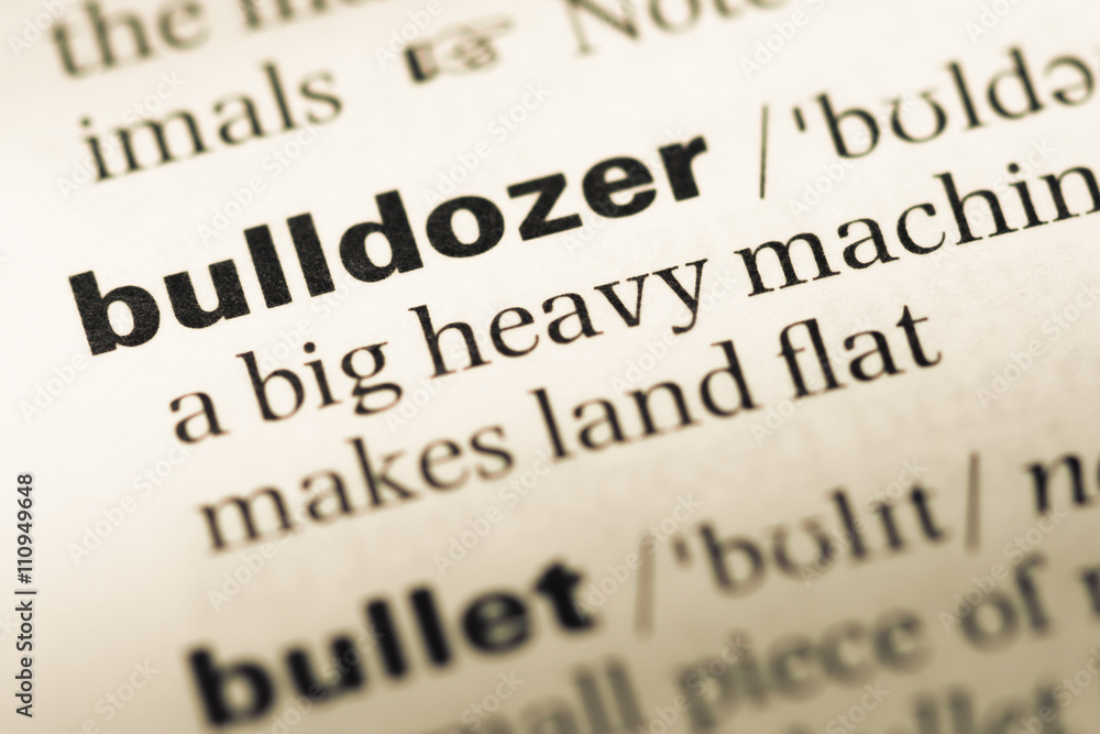 Close up of old English dictionary page with word bulldozer Close up of old English dictionary page with word bulldozer