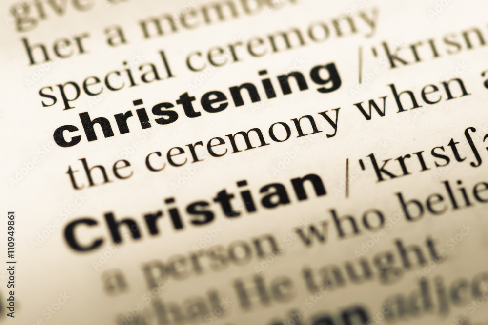 Close up of old English dictionary page with word christening Close up of old English dictionary page with word christening