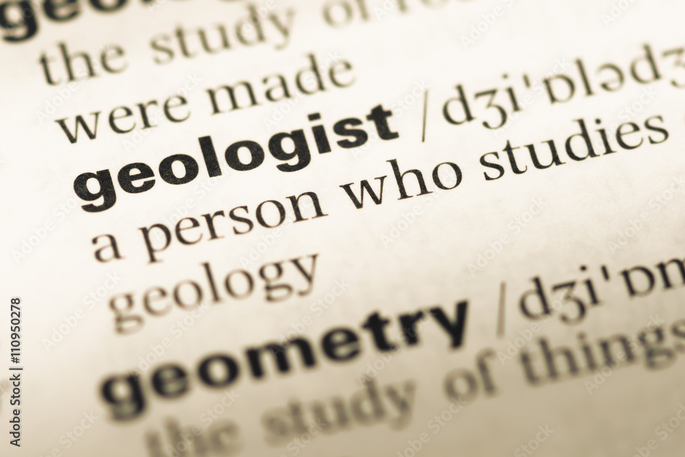 Close up of old English dictionary page with word geologist Close up of old English dictionary page with word geologist
