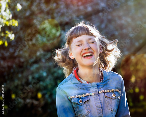 Beautiful, young girl, teenager laughing. Portrait of the girl's face closely. Park, nature. Sonce, the sun's rays photo