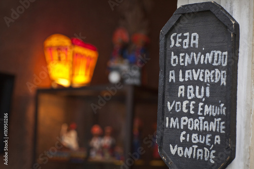 Sign welcoming customers, outside shop, close-up