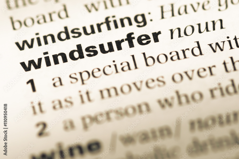 Close up of old English dictionary page with word windsurfer Close up of old English dictionary page with word windsurfer