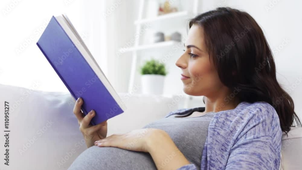 happy pregnant woman reading book at home happy pregnant woman reading book at home