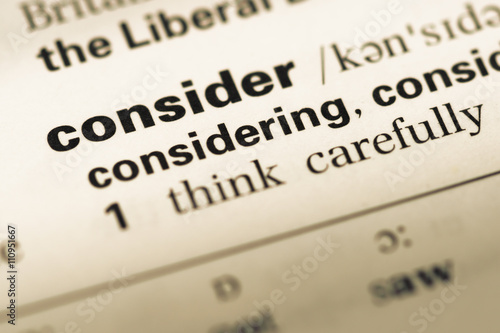 Close up of old English dictionary page with word consider