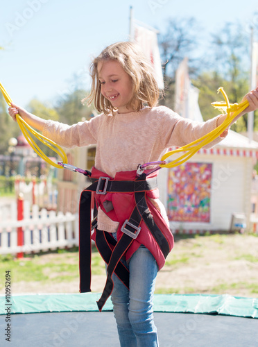 Photography Little girl on bungee trampoline with cords.
