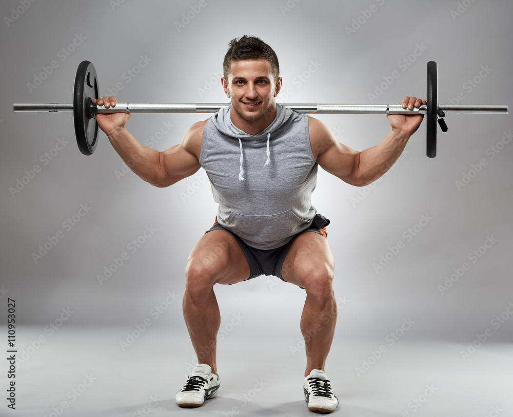 Man doing squats with barbell