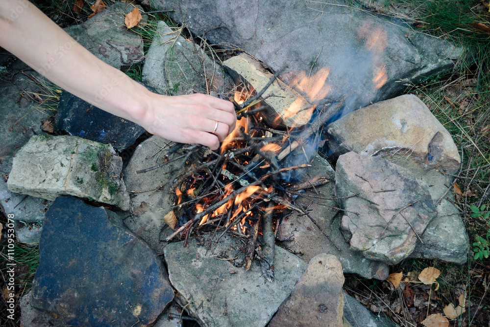 kindling a fire in the mountains on the rocks kindling a fire in the mountains on the rocks