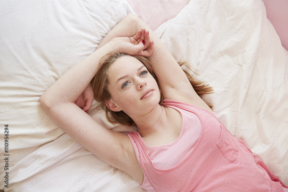 Girl lying on bed gazing upwards Girl lying on bed gazing upwards